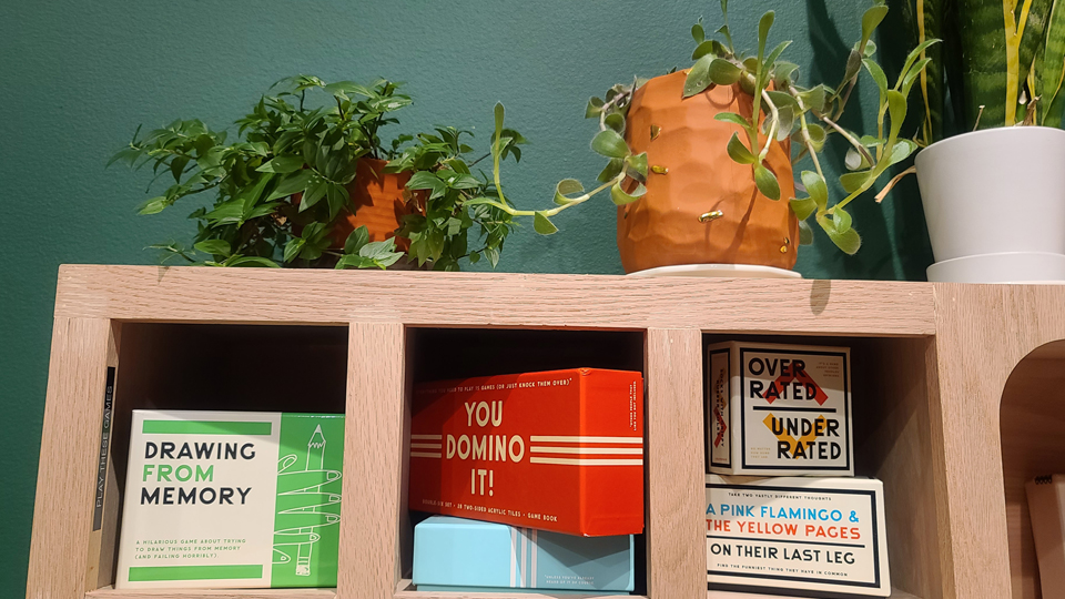 a shelf with various board and card games on it