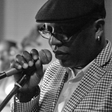 Glenn North holding a microphone