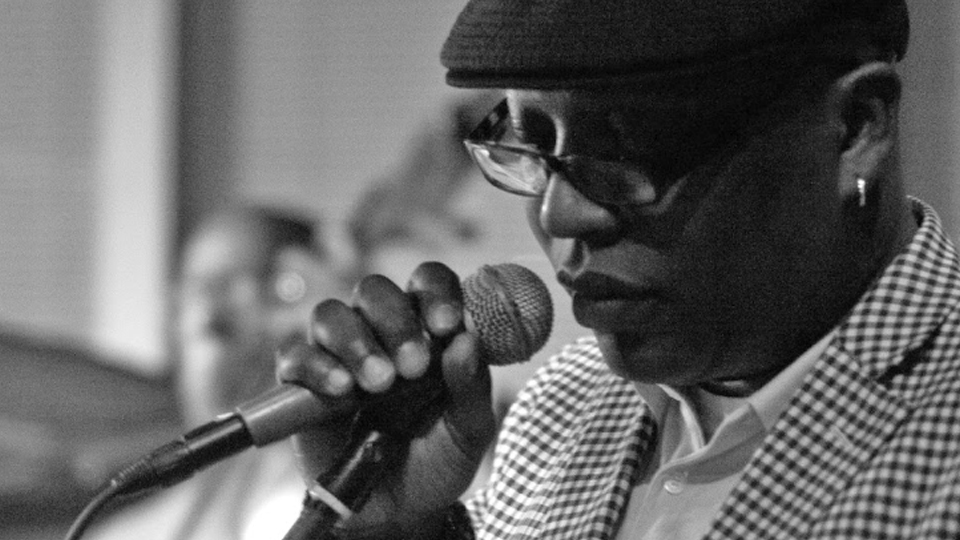 Glenn North holding a microphone