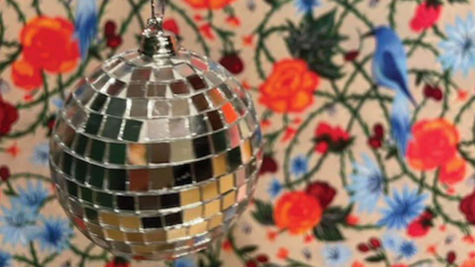 a disco ball and floral wallpaper