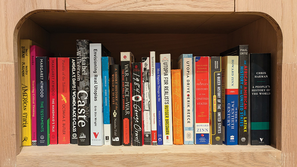 a row of books on a wooden shelf