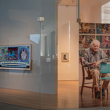 A portrait of Zig Priede hangs in the window of the Kansas Focus Gallery at the Nerman Museum of Art