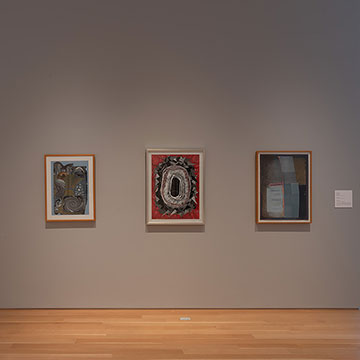 A view of a wall within the Kansas Focus Gallery displaying three works in the Aggregates of Time exhibition