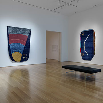 3 works by Teresa Baker hanging on the wall at the Nerman Museum
