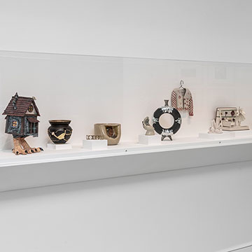 A view of the shooting stars exhibition at the Nerman showing a case with sculptures displayed along a shelf