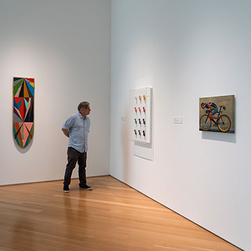 a man views a work of art at the These Colors Will Not Run exhibition at the Nerman Museum