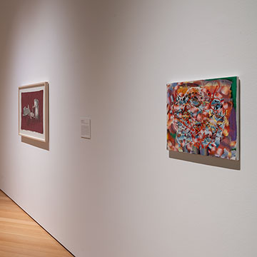 three works of art hang on the wall at the Nerman Museum