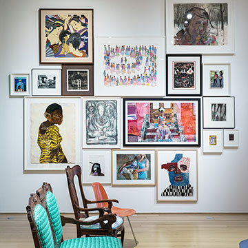 A grouping of artworks in frames arranged on the wall of the Salon exhibition.