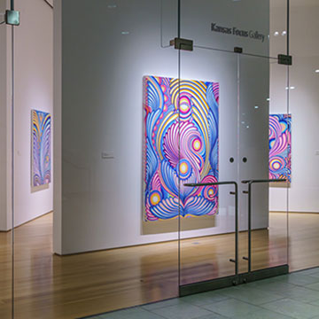 a wide-angle shot of the Kansas Focus Gallery at the Nerman Museum displaying paintings by Angeline Rivas