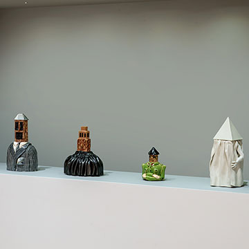 4 sculptures in a wall nook.