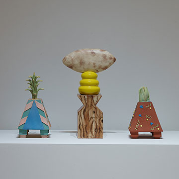 3 brightly-colored, geometrically-shaped ceramic sculptures created by Linda Lighton.
