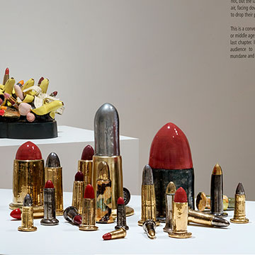 sculptures by Linda Lighton of ammunition that is colored similar to lipstick tubes