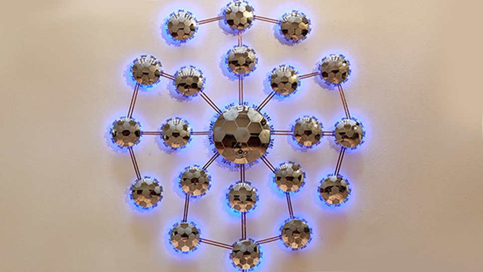 a grouping of backlit mirrors in a similar pattern to a soccer ball