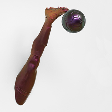 sculpture of a leg and foot kicking a soccer ball