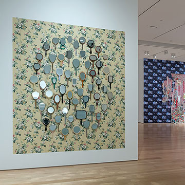 Installation showing a grouping of hand mirrors at the Adorned Exhibition at the Nerman